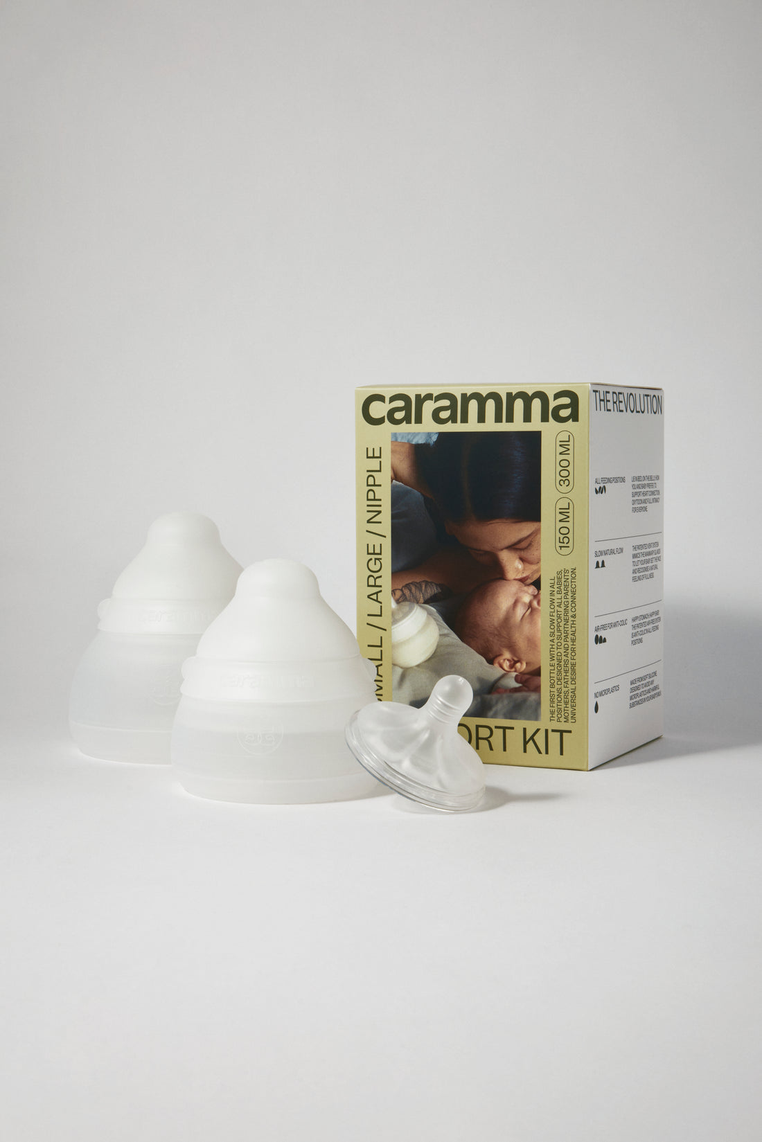 Caramma baby bottle support kit with one large bottle, one small bottle, and extra nipple for flexible feeding routines.
