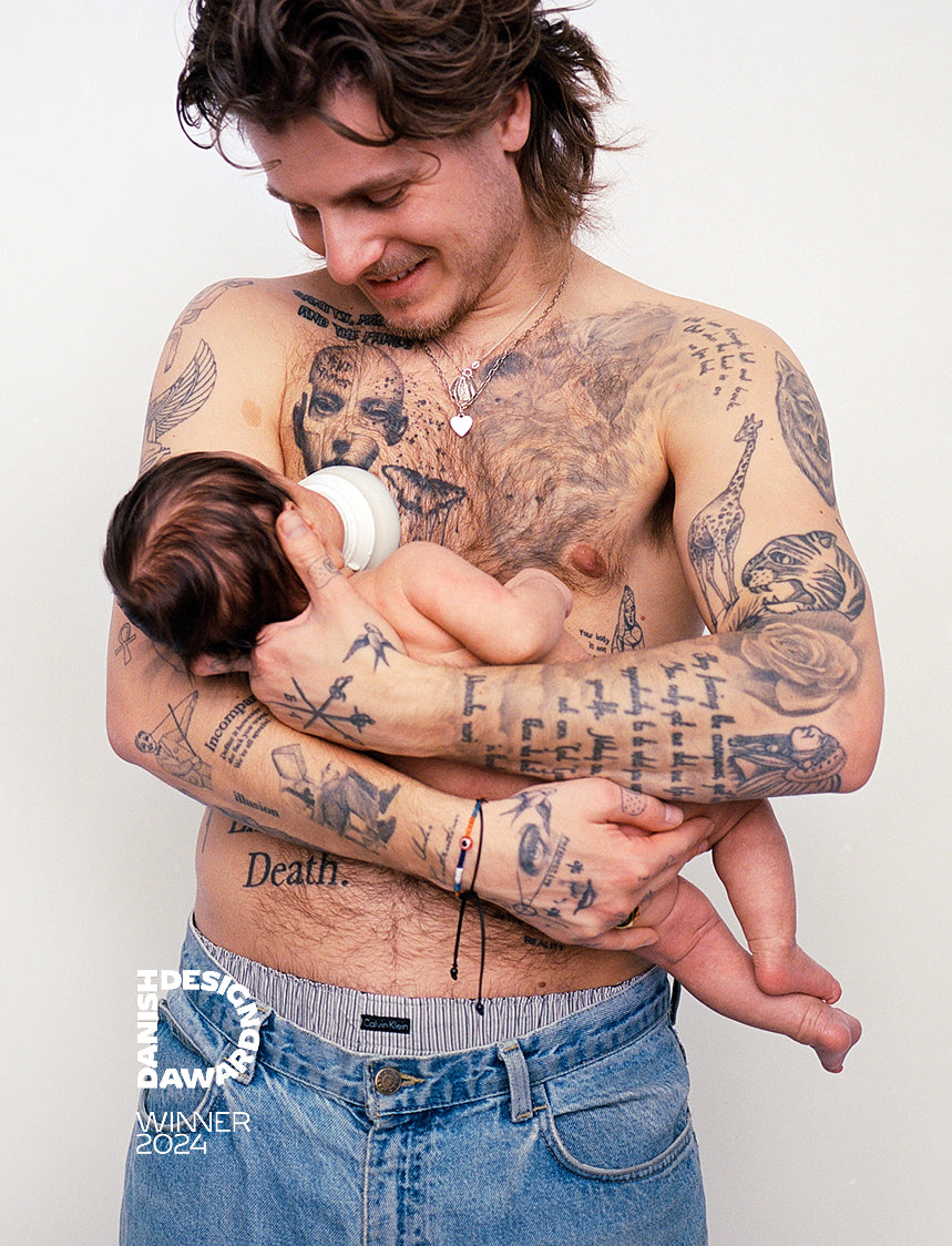Father feeding infant with Caramma slow-flow bottle in natural breastfeeding position. Petra Kleis