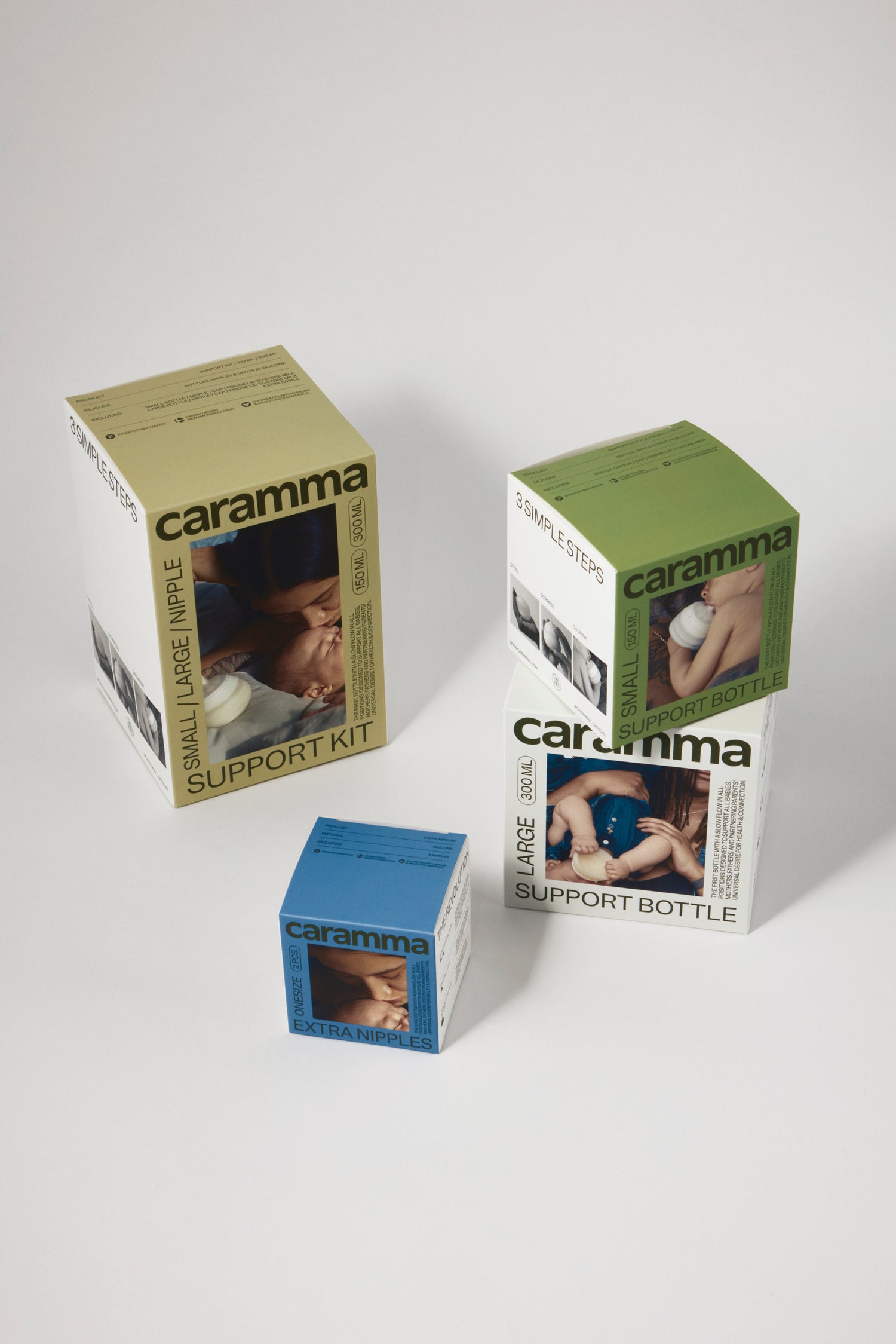 Complete Caramma baby bottle collection including large and small bottles, extra nipples, and feeding support kit for all infant stages