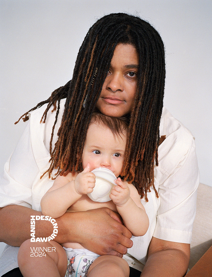 Mother and baby sharing a quiet moment while using Caramma baby bottle. Petra Kleis
