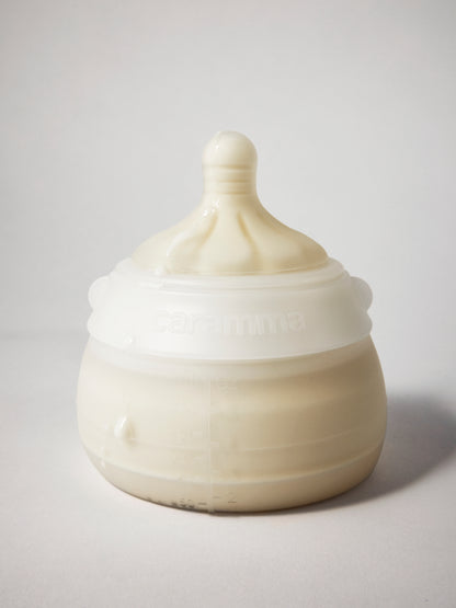 Caramma support bottle full of breastmilk or formula, ready to feed in all natural positions