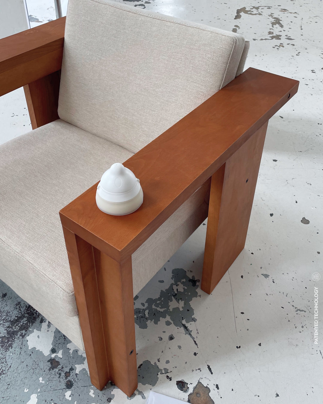 the caramma support baby bottle on Frama design chair, perfect design object for your home